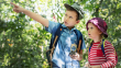 two cute kids trekking forest